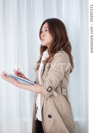 A woman writing a document 30895331