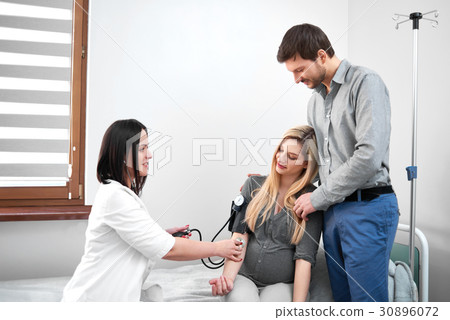 Doctor diagnosing for pregnant woman of measuring Doctor diagnosing for pregnant woman of measuring 30896072