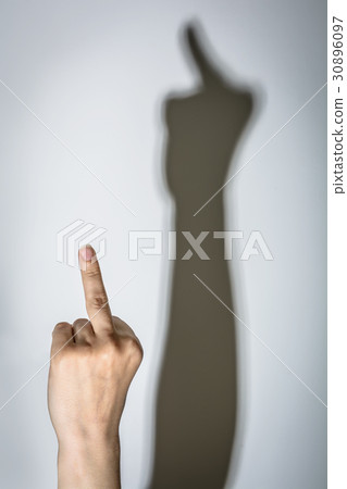 Woman show middle finger. Shadow on the wall 30896097