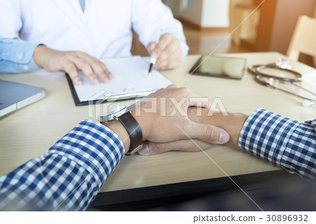 patient listening intently to a male doctor explaining patient s patient listening intently to a male doctor explaining patient s 30896932
