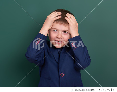 school boy portrait near green blank background 30897018