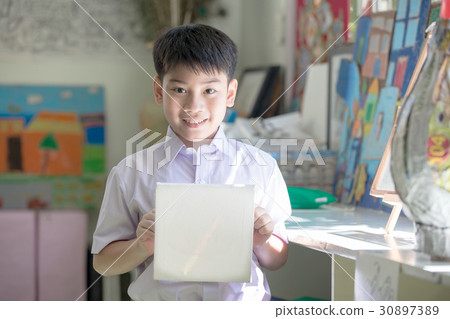 Asian child show his craft and looking camera 30897389