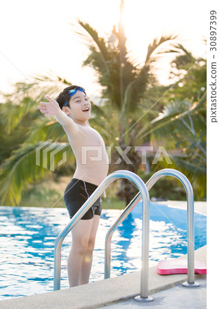 Happy asian boy in swimsuit coming up the pool 30897399