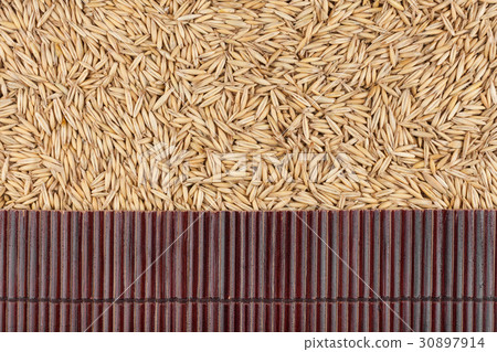 Beautiful bamboo mat on oat grains Beautiful bamboo mat on oat grains 30897914