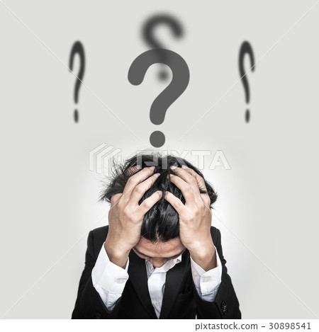 Confused businessman with question marks sign  30898541