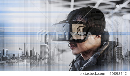 a guy wearing virtual reality googles 30898542