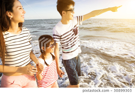 family walking on the beach at summer vacation 30899303