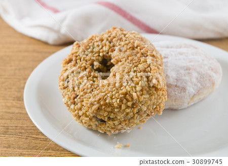 圖庫照片: strawberry jam filled donut and peanuts donut