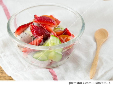Glass Bowl of Delicious Refreshing Fruits Salad 30899803
