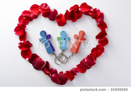Wooden figures of family into heart from petals Wooden figures of family into heart from petals 30899890