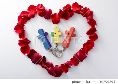 Wooden figures of family into heart from petails Wooden figures of family into heart from petails 30899891