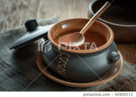 Clay pot for baking with lid with wooden spoon on Clay pot for baking with lid with wooden spoon on 30900513
