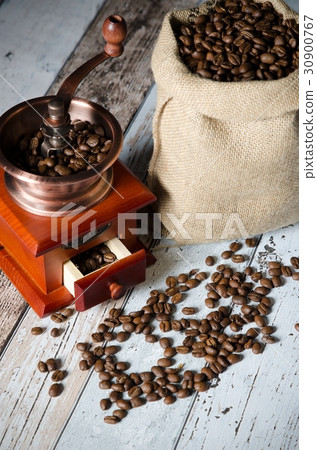 Coffee grinder with roasted beans. 30900767