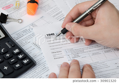 Man filling US tax form 30901320