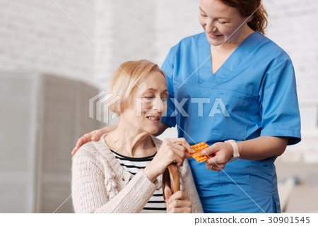 Graceful excellent doctor giving the medication 30901545