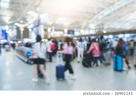 Blur people walking with luggage at airport 30902143