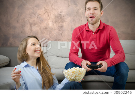Couple enjoys free time and playing video games. 30902246