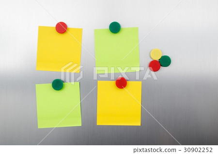 Coloured notes and magnets on inox metallic fridge 30902252