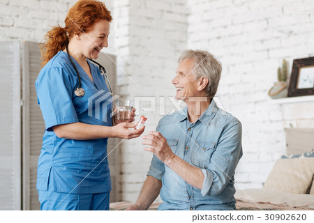 Competent positive lady helping elderly man 30902620