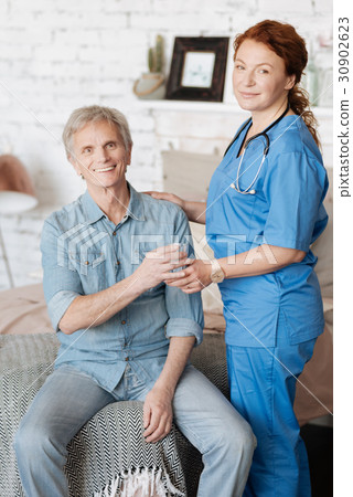 Proficient nurse providing medical assistance for Proficient nurse providing medical assistance for 30902623