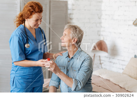 Qualified capable doctor assisting feeble man at Qualified capable doctor assisting feeble man at 30902624