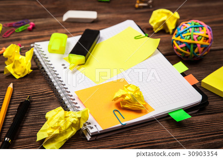 Open notepad with office supplies 30903354