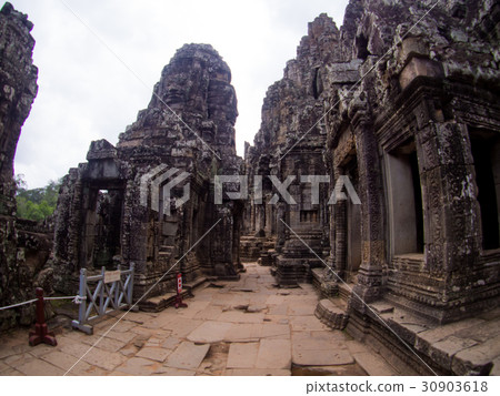 stone faces of ancient Bayon temple in Angkor Thom stone faces of ancient Bayon temple in Angkor Thom 30903618