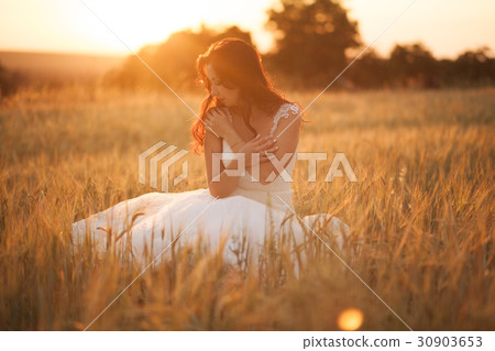 Happy beautiful young bride outside on a summer 30903653