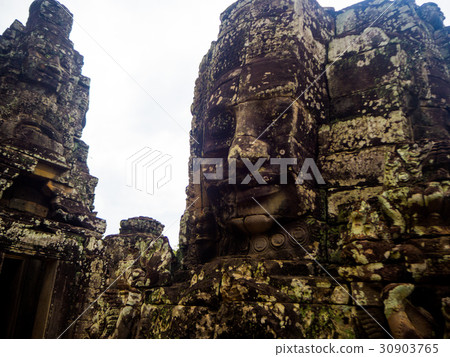 stone faces of ancient Bayon temple in Angkor Thom stone faces of ancient Bayon temple in Angkor Thom 30903765