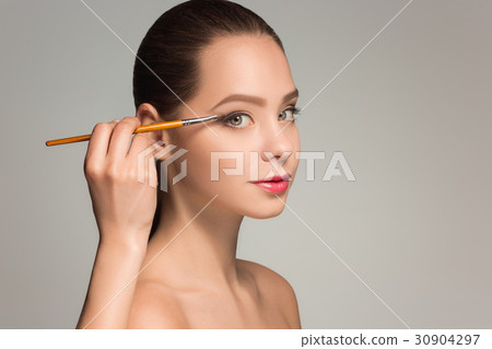 Beautiful female eyes with make-up and brush 30904297