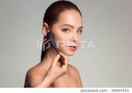 Beautiful female eyes with make-up and brush 30904303