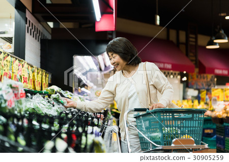 Senior woman shopping at supermarket 30905259