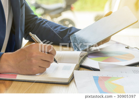 businessman writes business plan with tablet businessman writes business plan with tablet 30905397