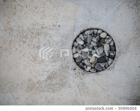 The gray stone is in the concrete hole.texture con The gray stone is in the concrete hole.texture con 30906808