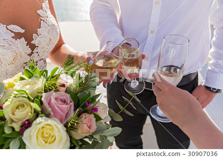 Flowers and wine glasses in the hands 30907036