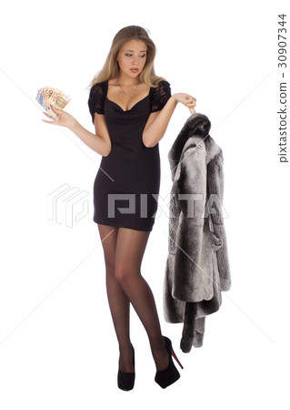 Attractive young woman with a fur coats and money 30907344