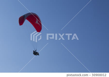 Paragliding in blue cloudy sky Paragliding in blue cloudy sky 30908012