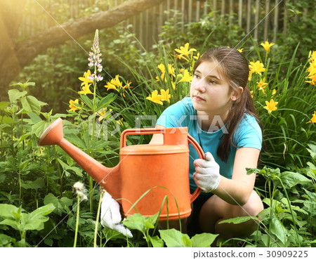 teenager girl with orange water can close up photo 30909225