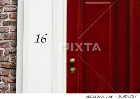 Classic red door with number 16. Vintage style 30909787