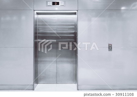 modern elevator with closed doors in lobby modern elevator with closed doors in lobby 30911108