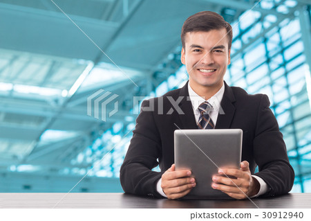 Businessman holding tablet Businessman holding tablet 30912940