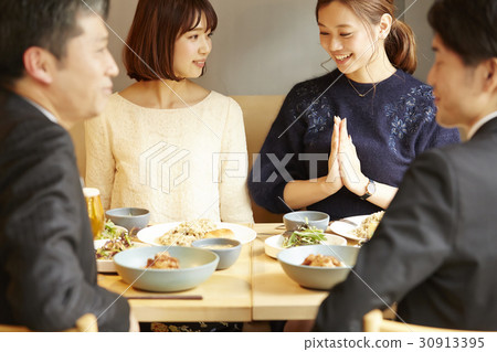 Men and women enjoying a meal Men and women enjoying a meal 30913395