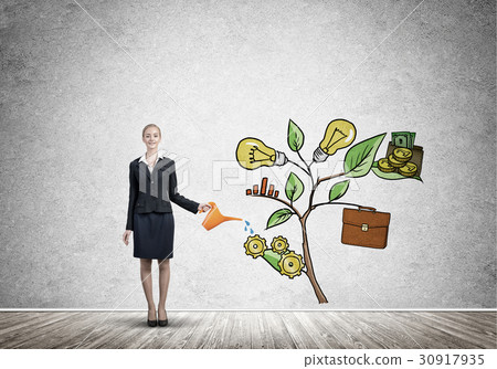 Young businesswoman in empty room watering drawn growth concept with can 30917935
