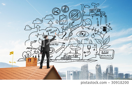 Rear view of businessman on house roof drawing his new business strategy. Mixed media Rear view of businessman on house roof drawing his new business strategy. Mixed media 30918200