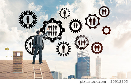 Businessman on house roof presenting teamwork and connection con 30918595