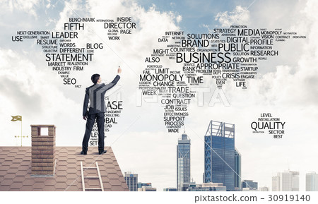 Businessman on brick roof draw world map as concept of globaliza 30919140