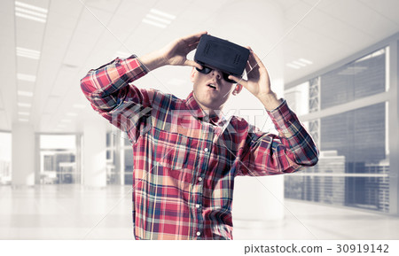 Concept of modern entertaining technologies with man wearing virtual reality mask 30919142