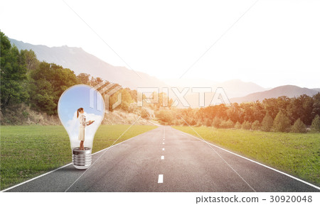 Businesswoman inside light bulb Businesswoman inside light bulb 30920048
