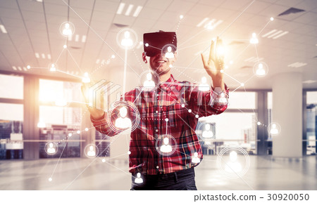 Guy wearing checked shirt and virtual mask reaching hand to touch screen 30920050