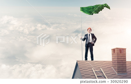 Young businessman with flag presenting concept of leadership. Mi Young businessman with flag presenting concept of leadership. Mi 30920290